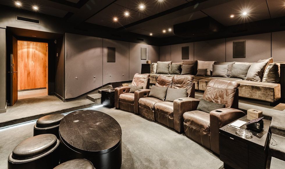 The home theatre with two tiers of luxury seating.