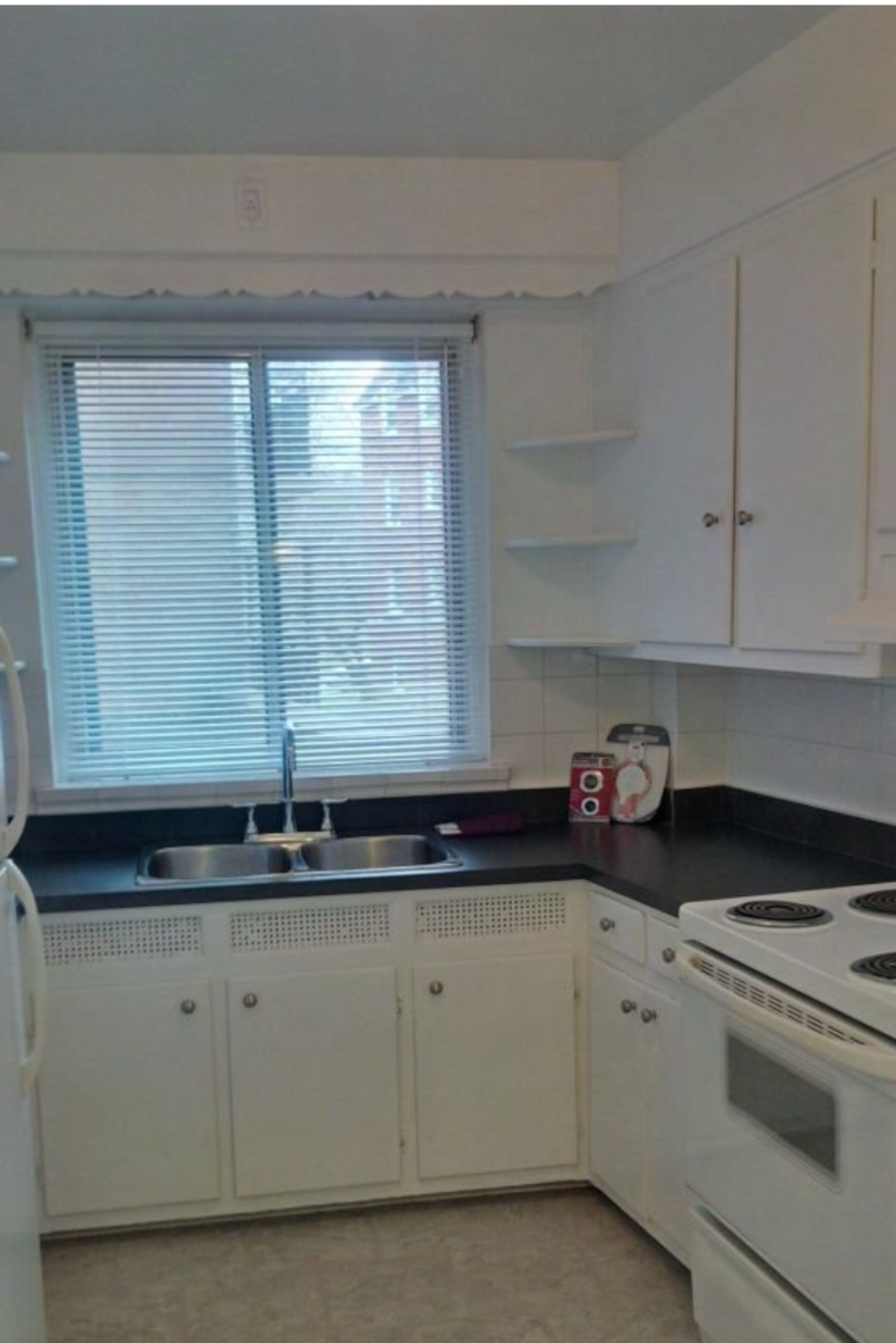The kitchen in a one-bedroom apartment.