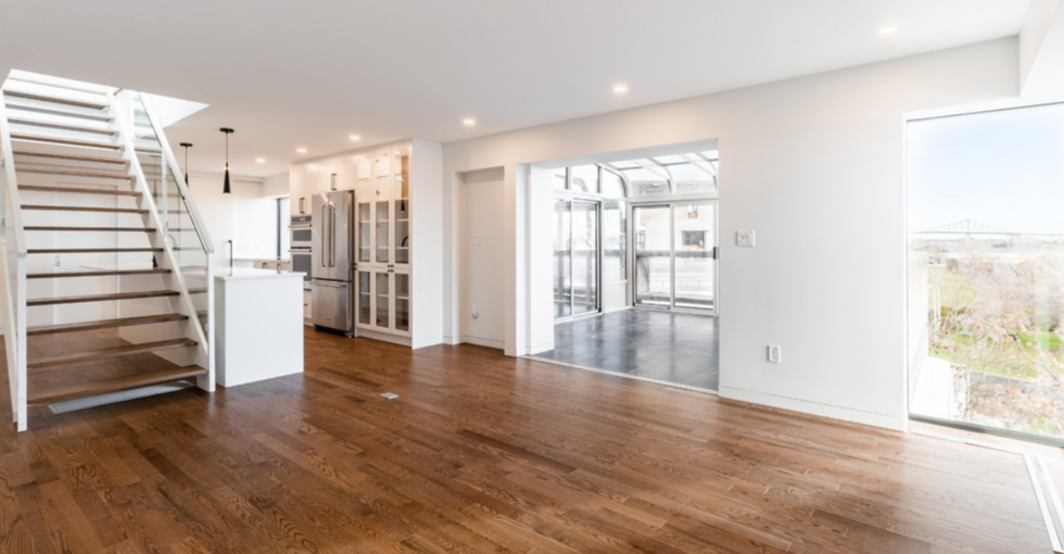 The living room on the first floor of a condo for sale in Habitat 67.
