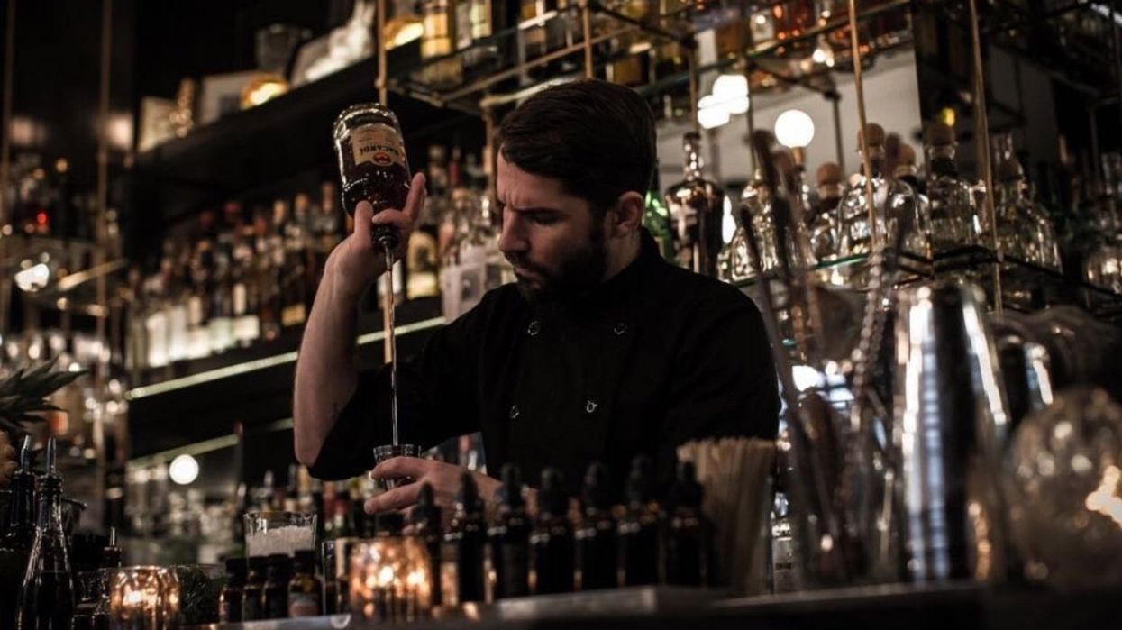 The mixologist at The Cloakroom Bar in Montreal preparing a drink.