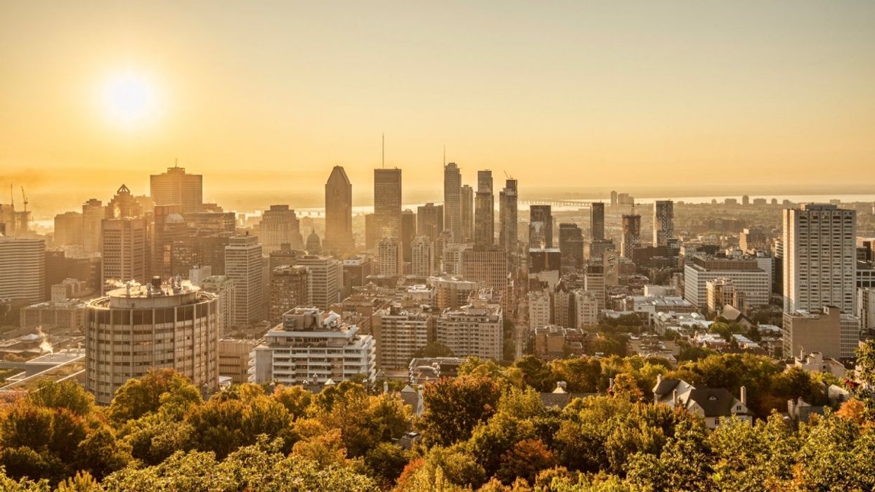 The Montreal skyline during a heat wave with the blistering sun in the distance.