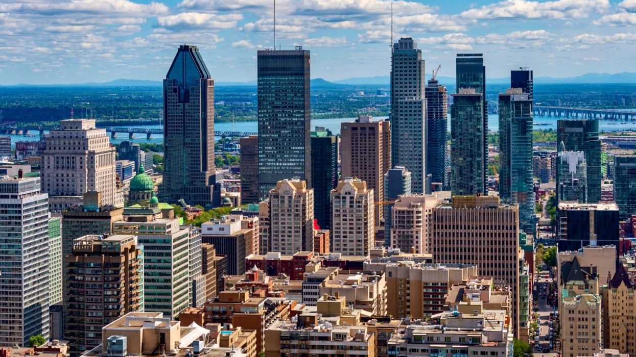 The Montreal skyline during the summertime taken from the Mont-Royal lookout with tens of skyscrapers in the background.