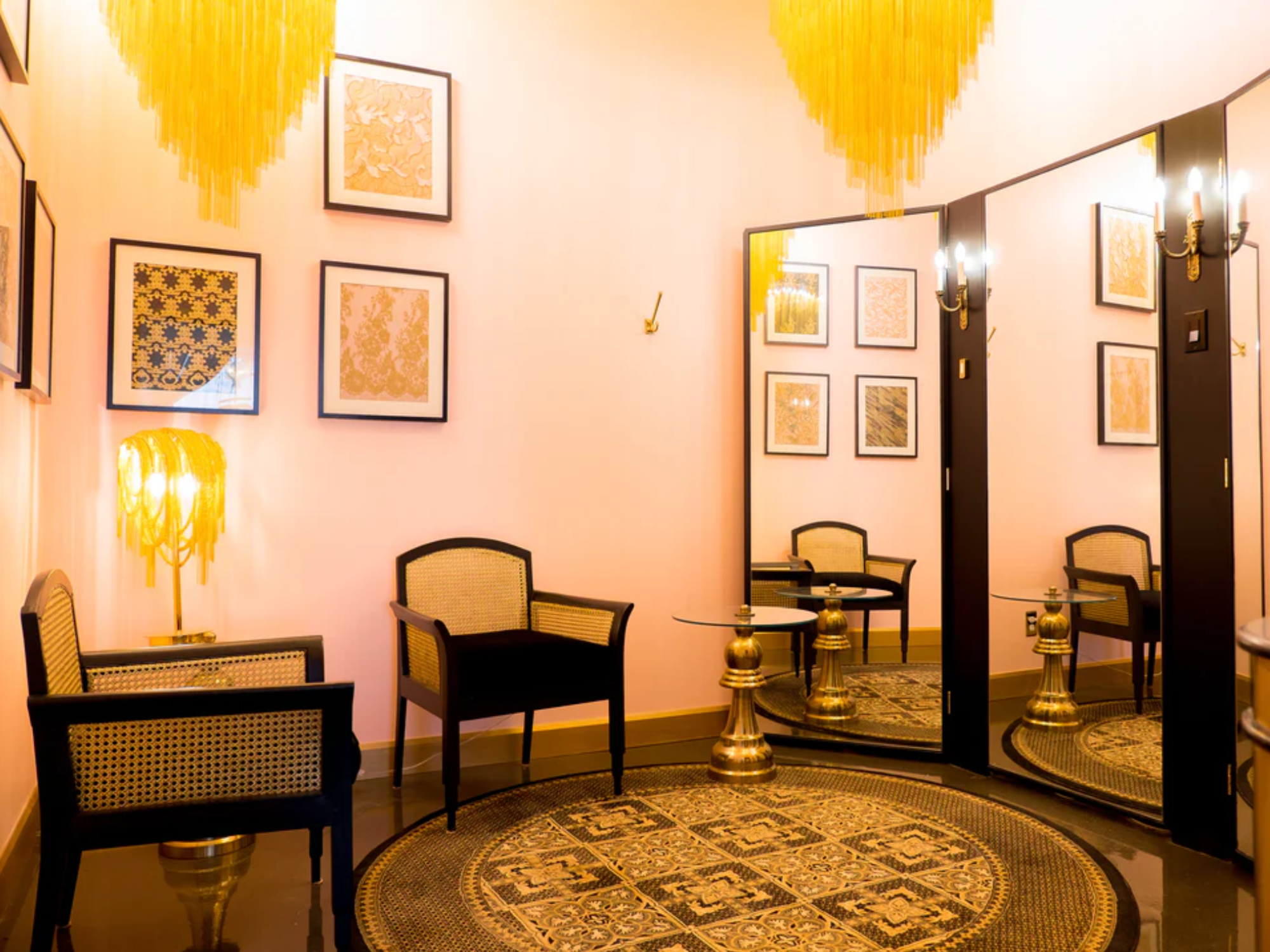 The "Nicole" dressing room with pink walls and gold accents.