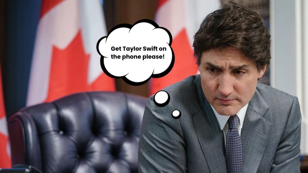The Prime Minister of Canada Justin Trudeau sitting at his desk with a pensive look on his face.