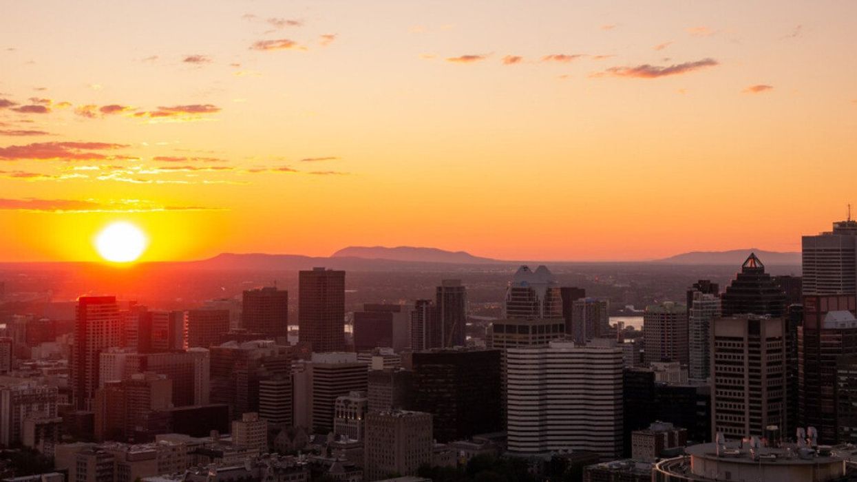 The sun rises over the Montreal skyline.