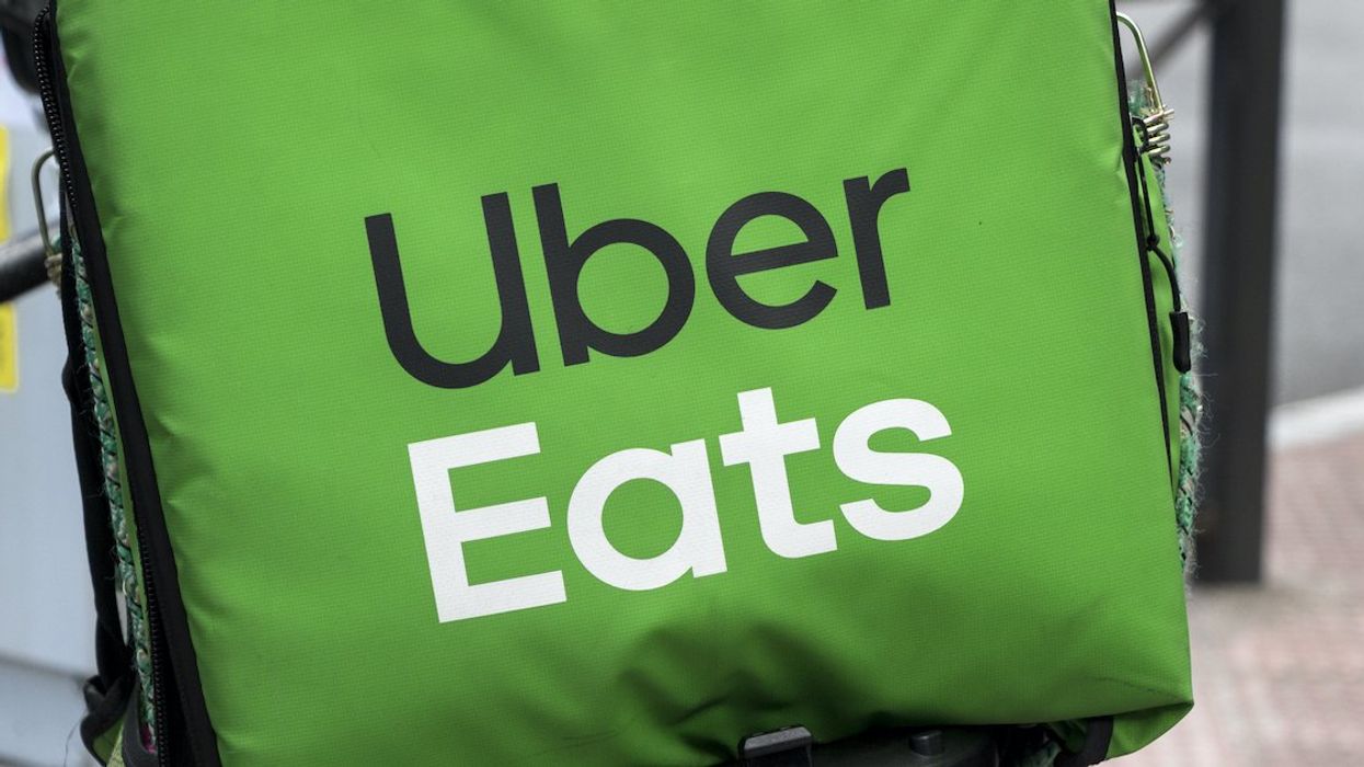The Uber Eats logo on a delivery food container.