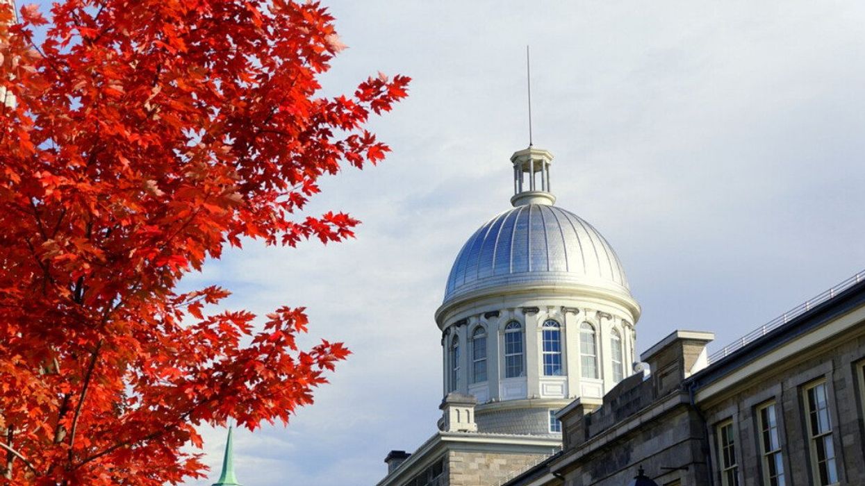 The view of the exterior dome of Bonsecours Market surrounded by striking red color of fall foliage.