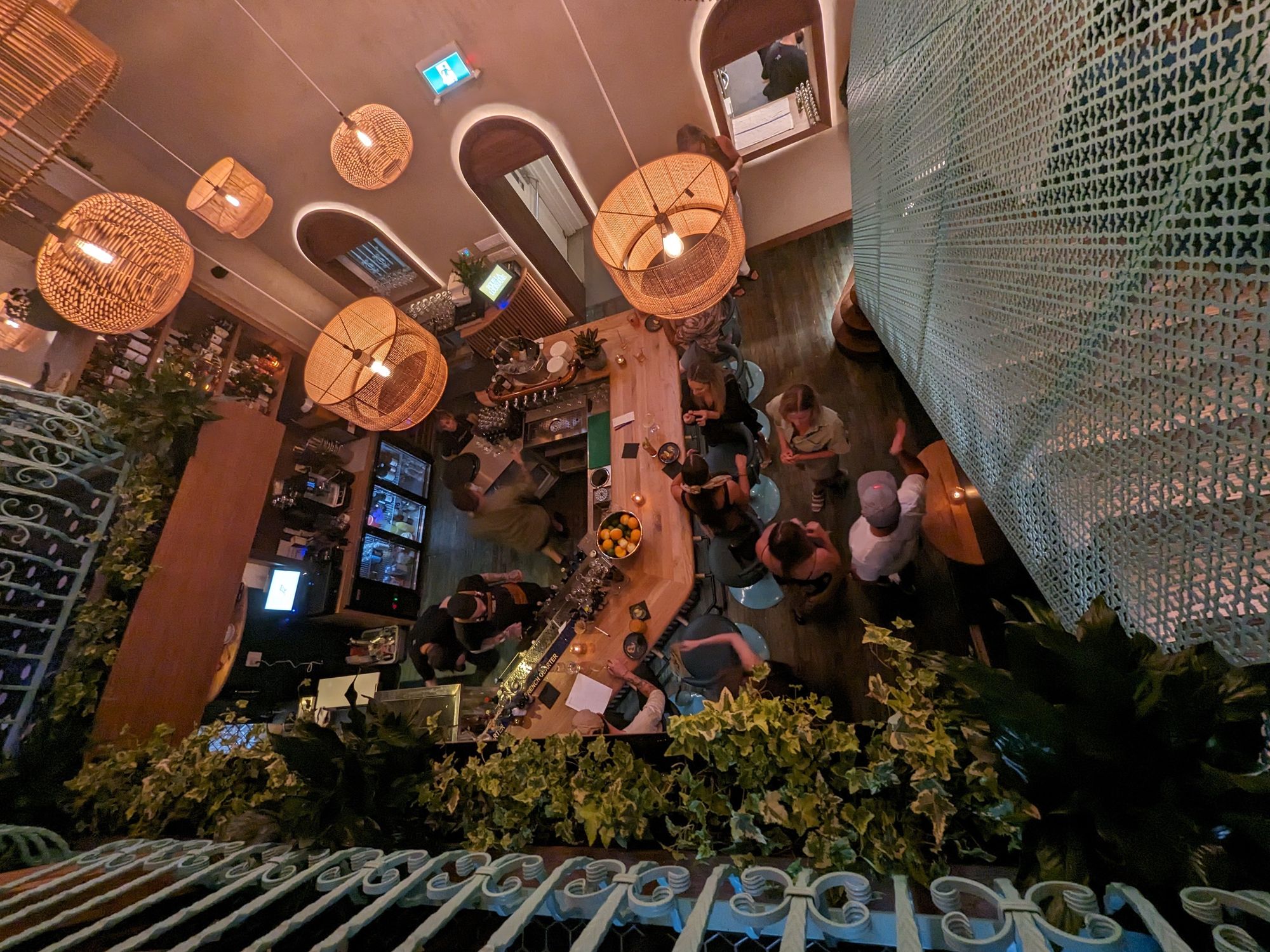 The view of the restaurant from the second floor, looking over the teal railing.