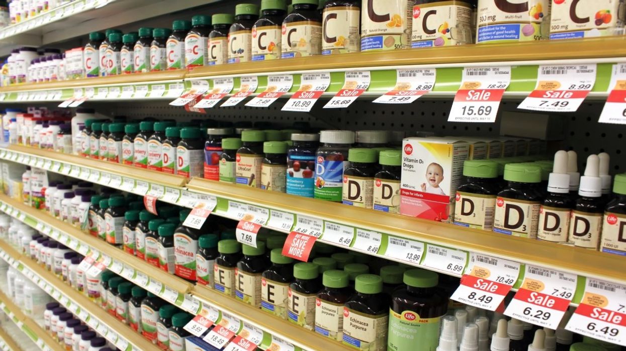 The vitamin and supplement aisle at a pharmacy. 