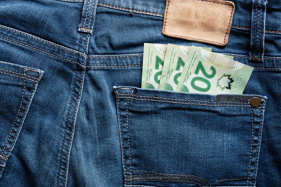 Three Canadian twenties in the back pocket of a pair of jeans.