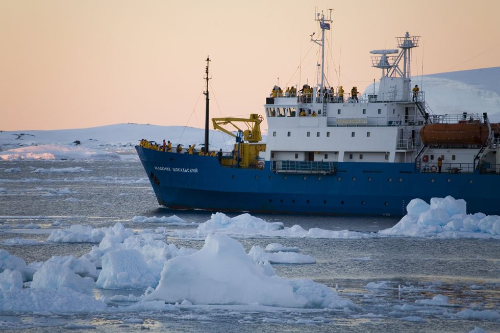 Tourist icebreaker navigates through sea ice in the Lamaire Channel in Antarctica.