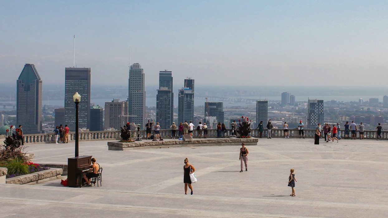 Tourists enjoying the Mount Royal Lookout in Montreal.