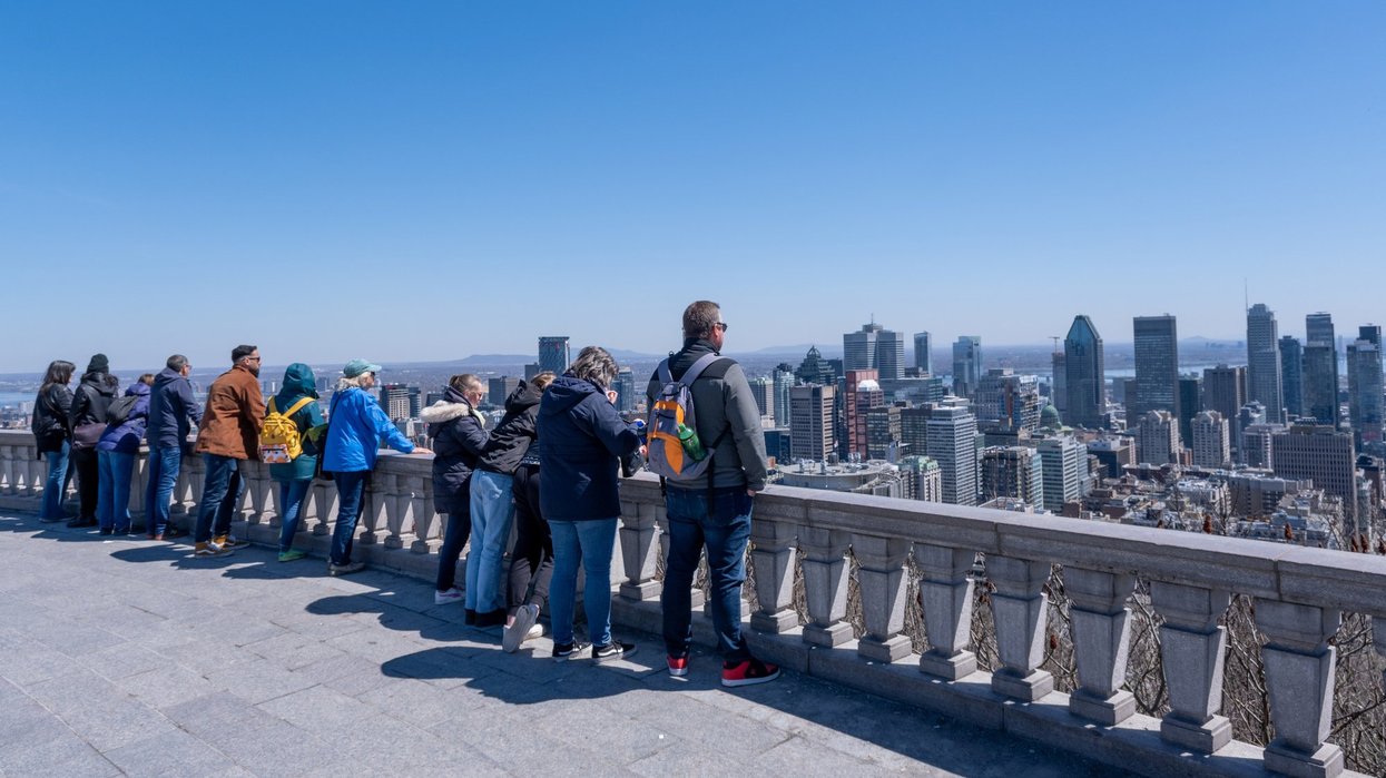 Tourists looking at Montreal skyline and enjoying a warm spring day at the Kondiaronk Belvedere