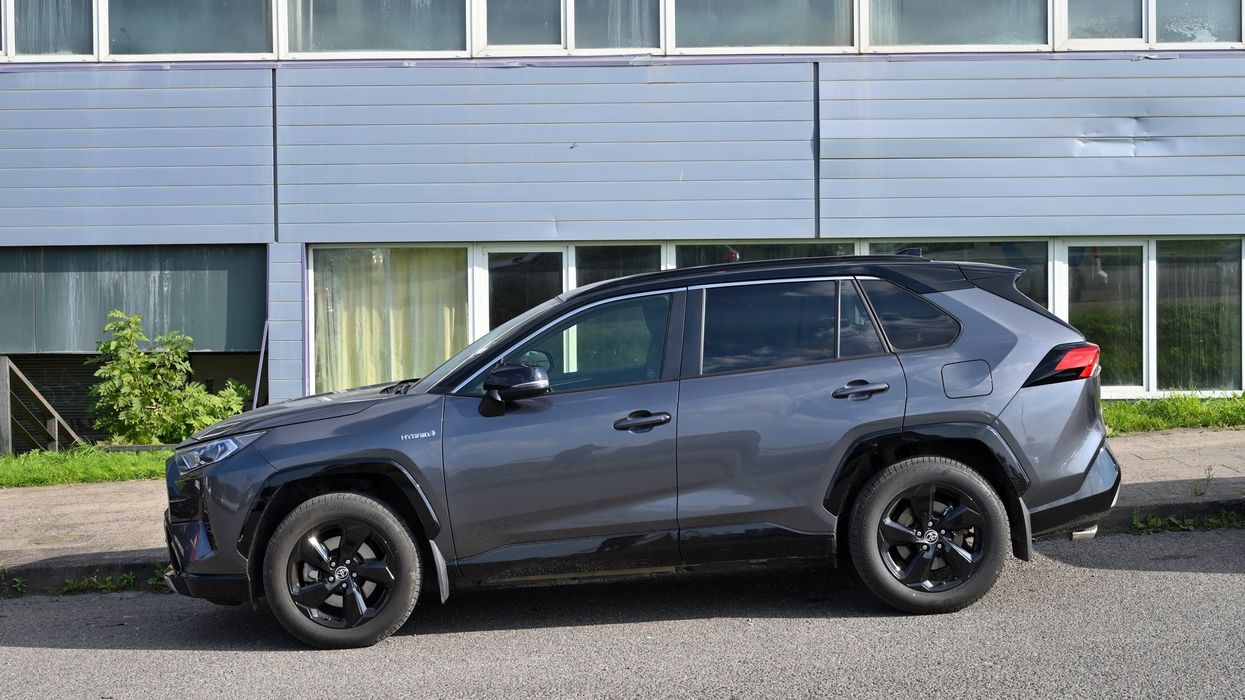 Toyota RAV-4, side view car at city public parking.