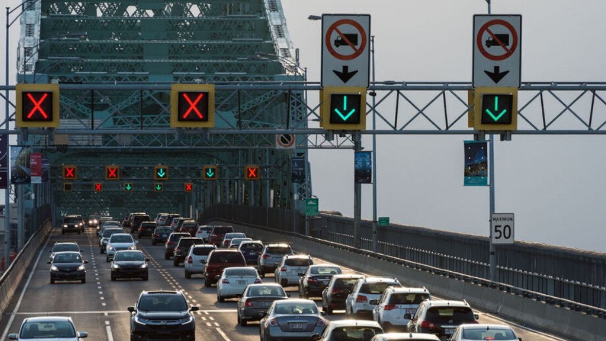 Traffic on Jacques Cartier bridge crossing Saint Lawrence river in Montreal.