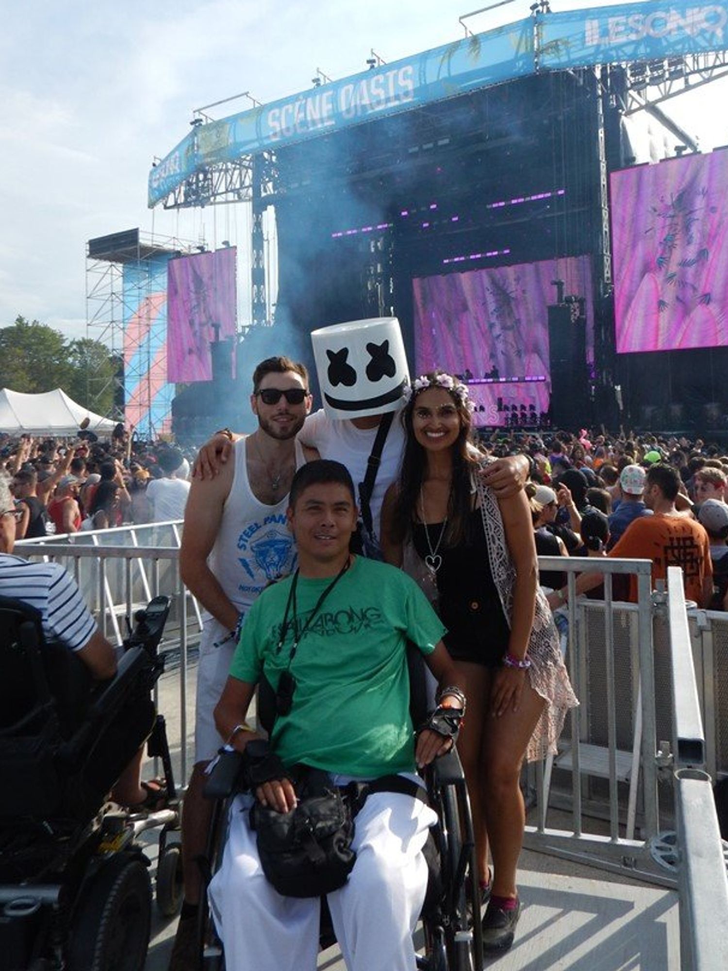 Travel blogger Alan Vuong with DJ Marshmello and friends on the accessible viewing platform at \u00ceLESONIQ.