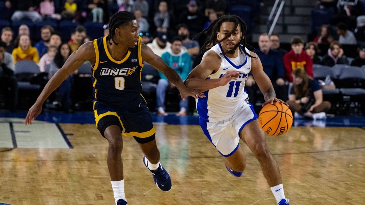 Two NCAA basketball players on the court.