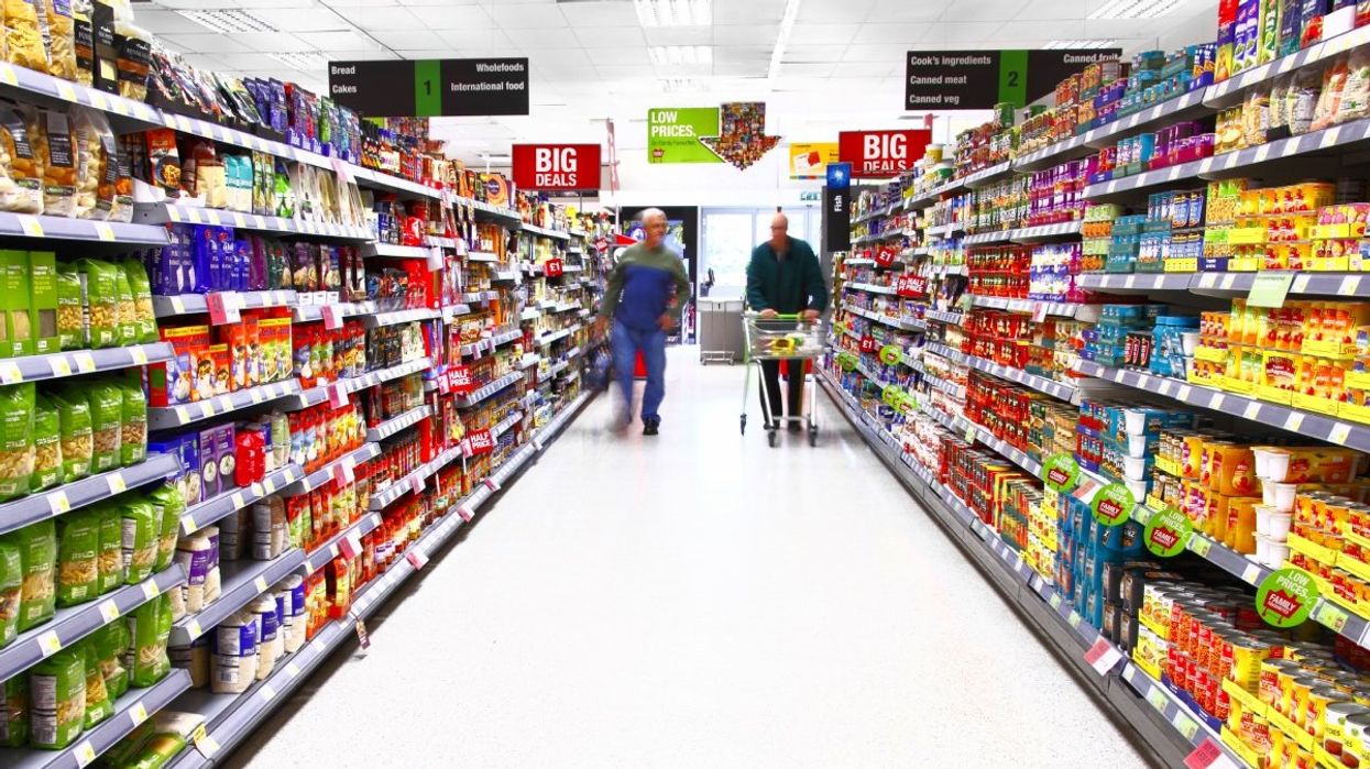 Two people grocery shopping at a supermarket in Canada.