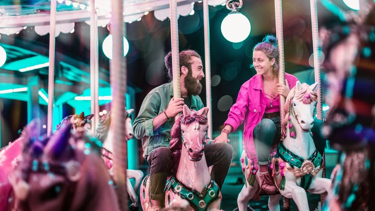 Two people on carousel horses.
