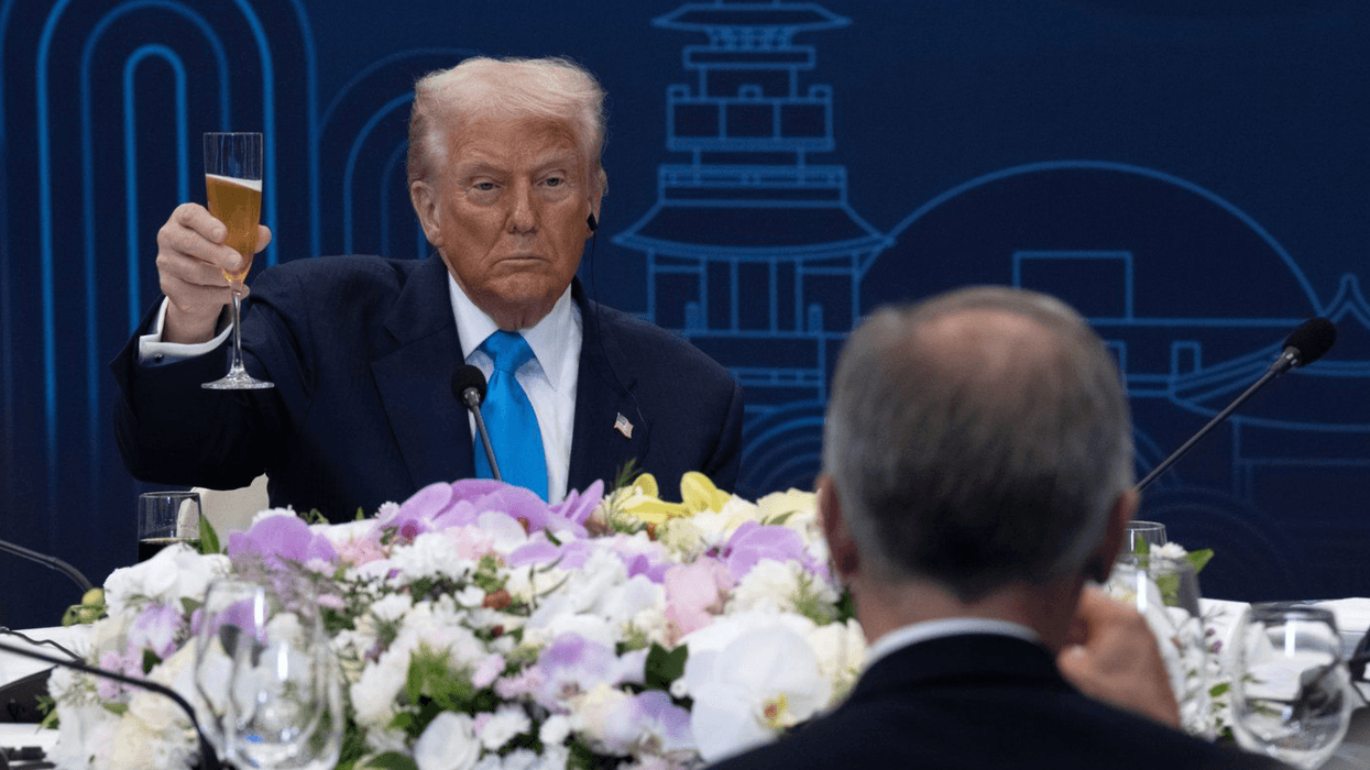 U.S. President Donald Trump looks toward Canadian Prime Minister Mark Carney as they raise their glasses during a toast at a working dinner in Gyeongju, South Korea, on Wednesday, Oct. 29, 2025.