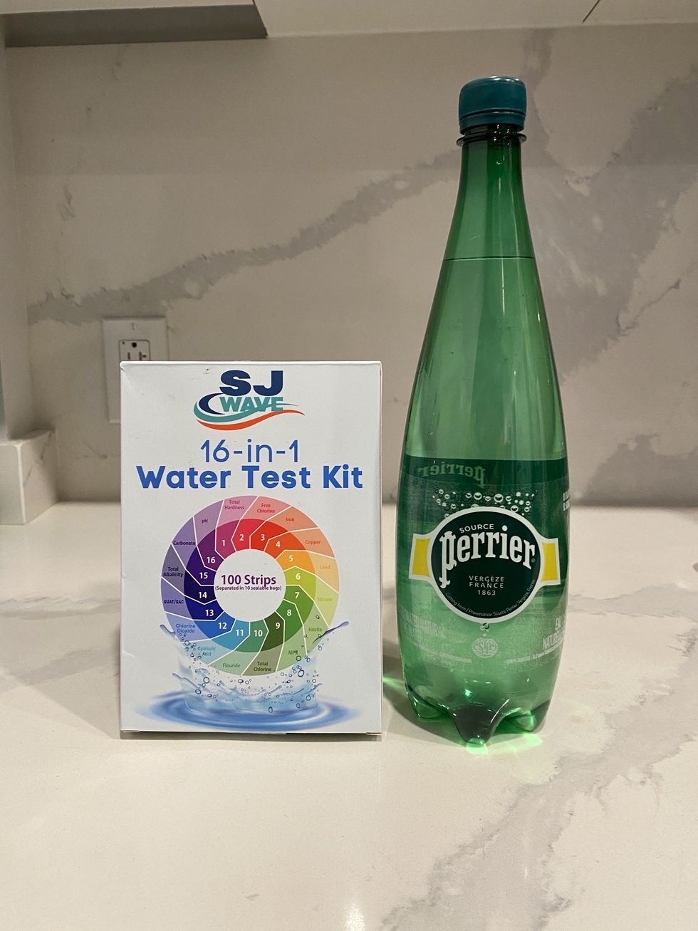 \u200bA bottle of Perrier sparkling water and a 16-in-1 water test kit.