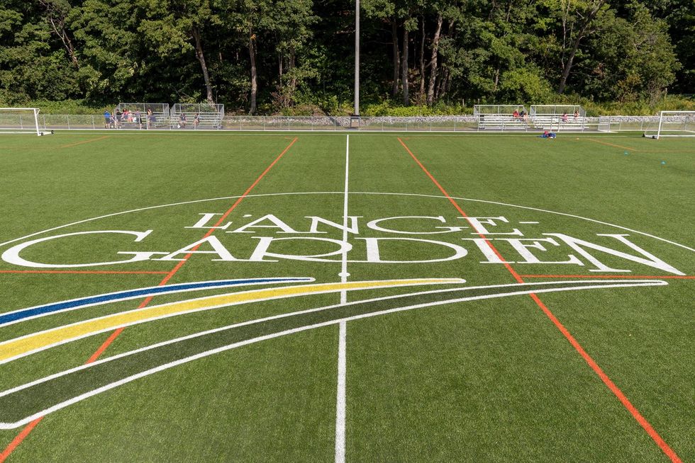 \u200bA field covered with the L'Ange-Gardien city logo.
