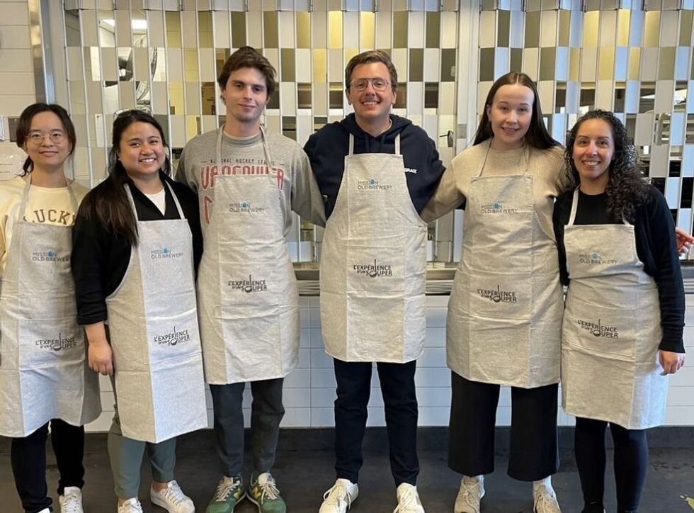 \u200bA group of Plusgrade employees wearing aprons.