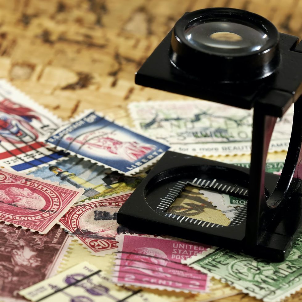 \u200bA stamp collection with a magnifying glass.