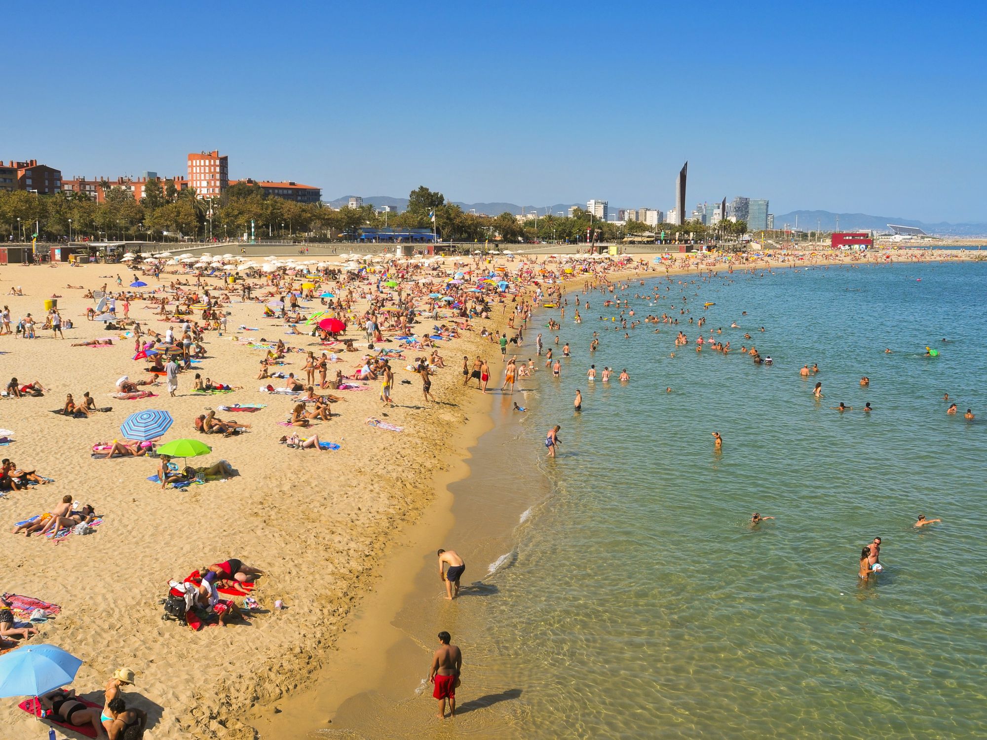 \u200bBathers in Nova Icaria Beach in Barcelona, Spain.