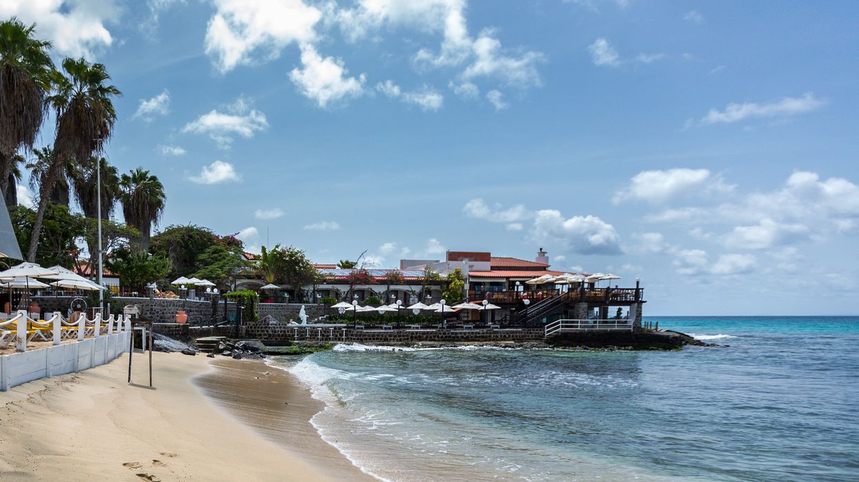 \u200bBuildings and palm trees at the beach of Sal Island in Cabo Verde.