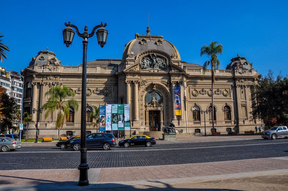 \u200bCars drive in front of the ornate Museum of Fine Arts in Santiago, Chile.
