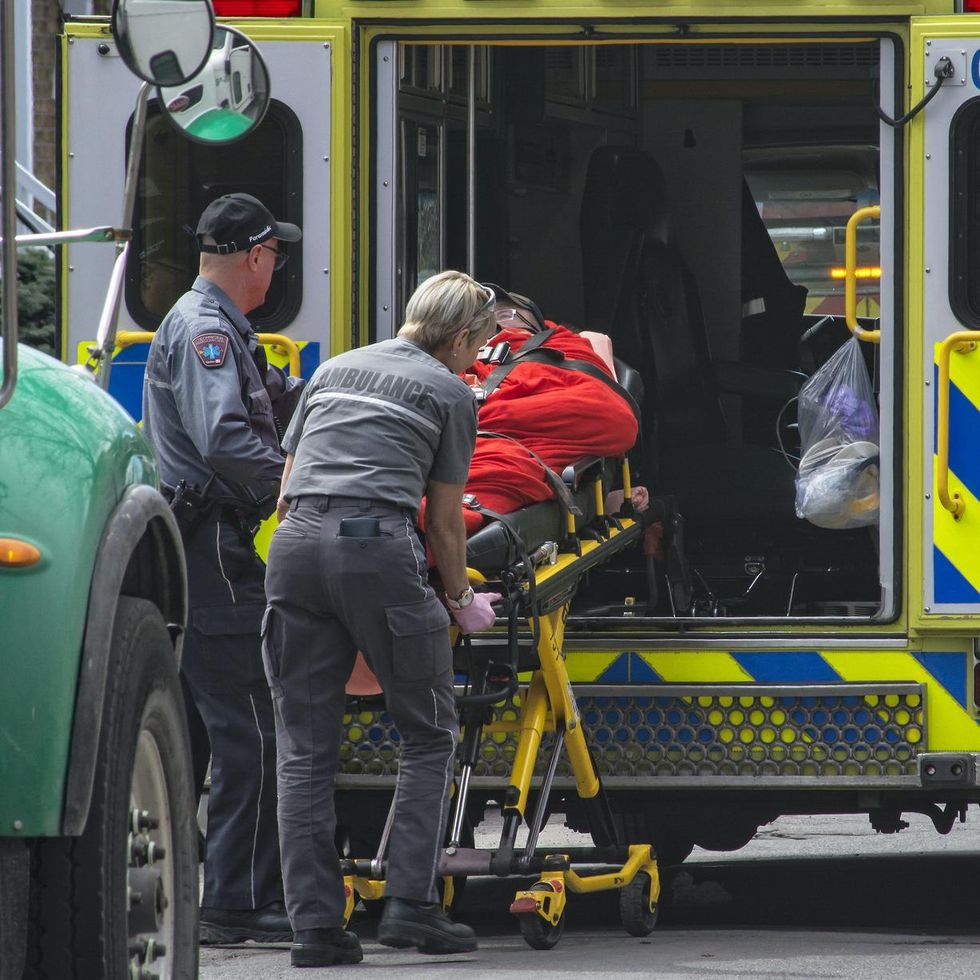 \u200bParamedics help someone into a Montreal ambulance.