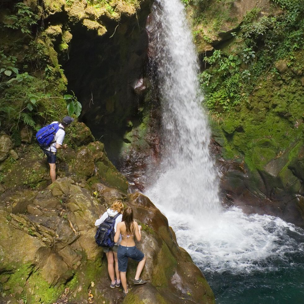\u200bPeople at Oropendola Waterfall in Costa Rica.