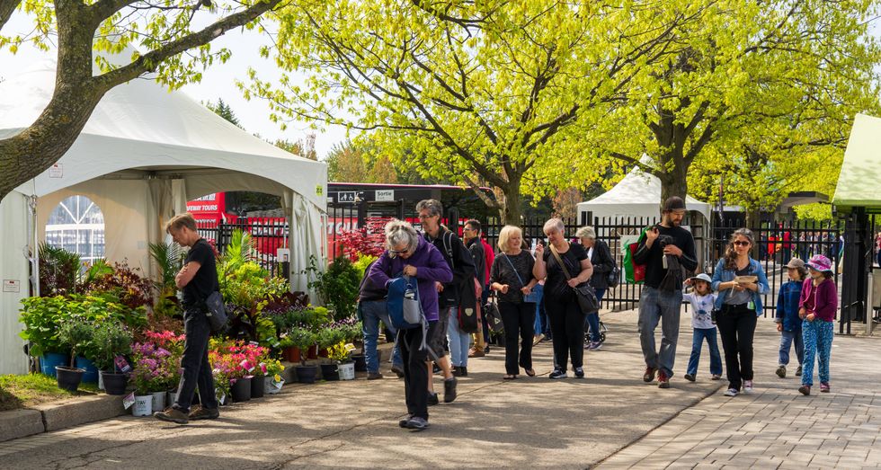 \u200bPeople pass a tent selling plants at the Montreal Botanical Garden plant sale.