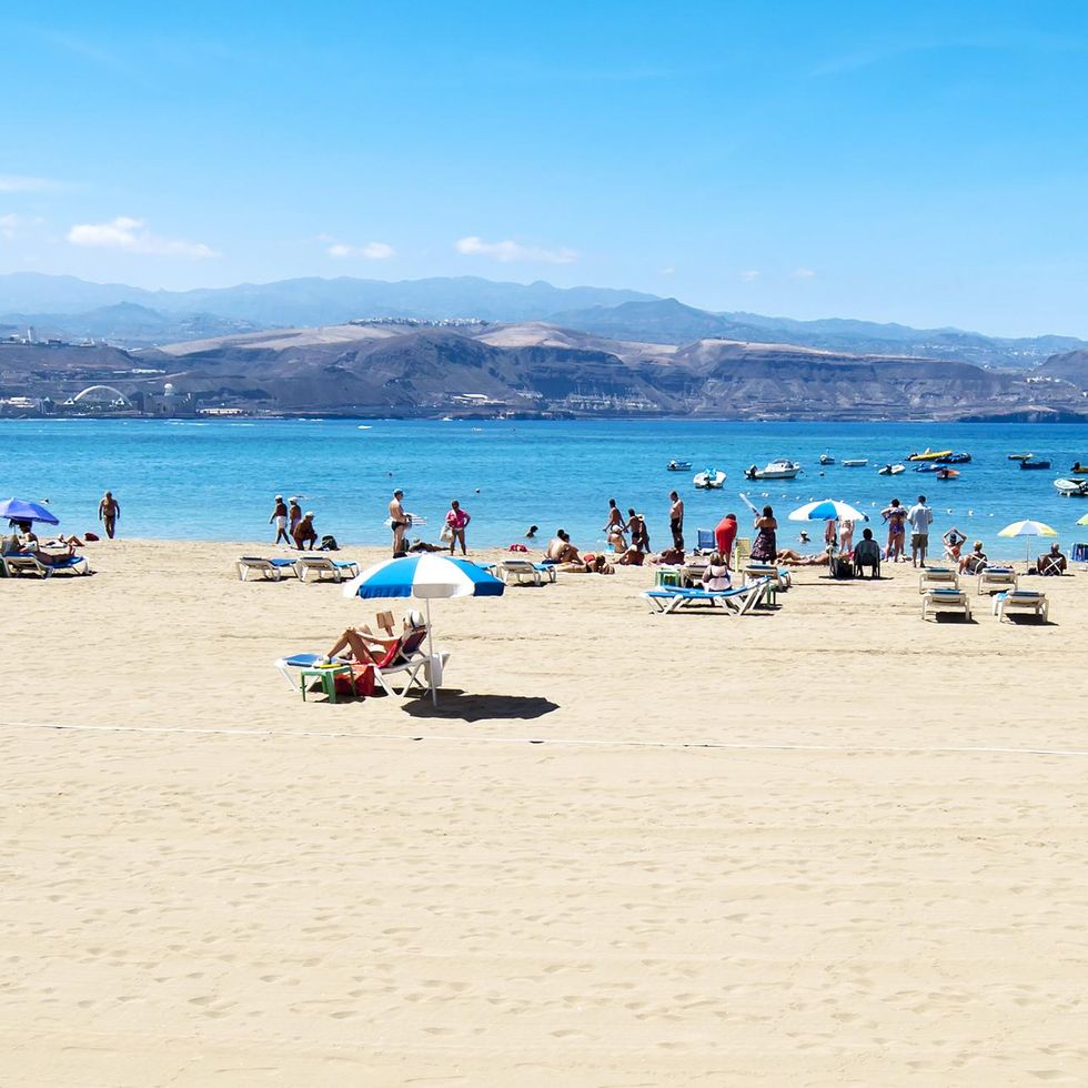 \u200bPeople relax on a beach in Gran Canaria.