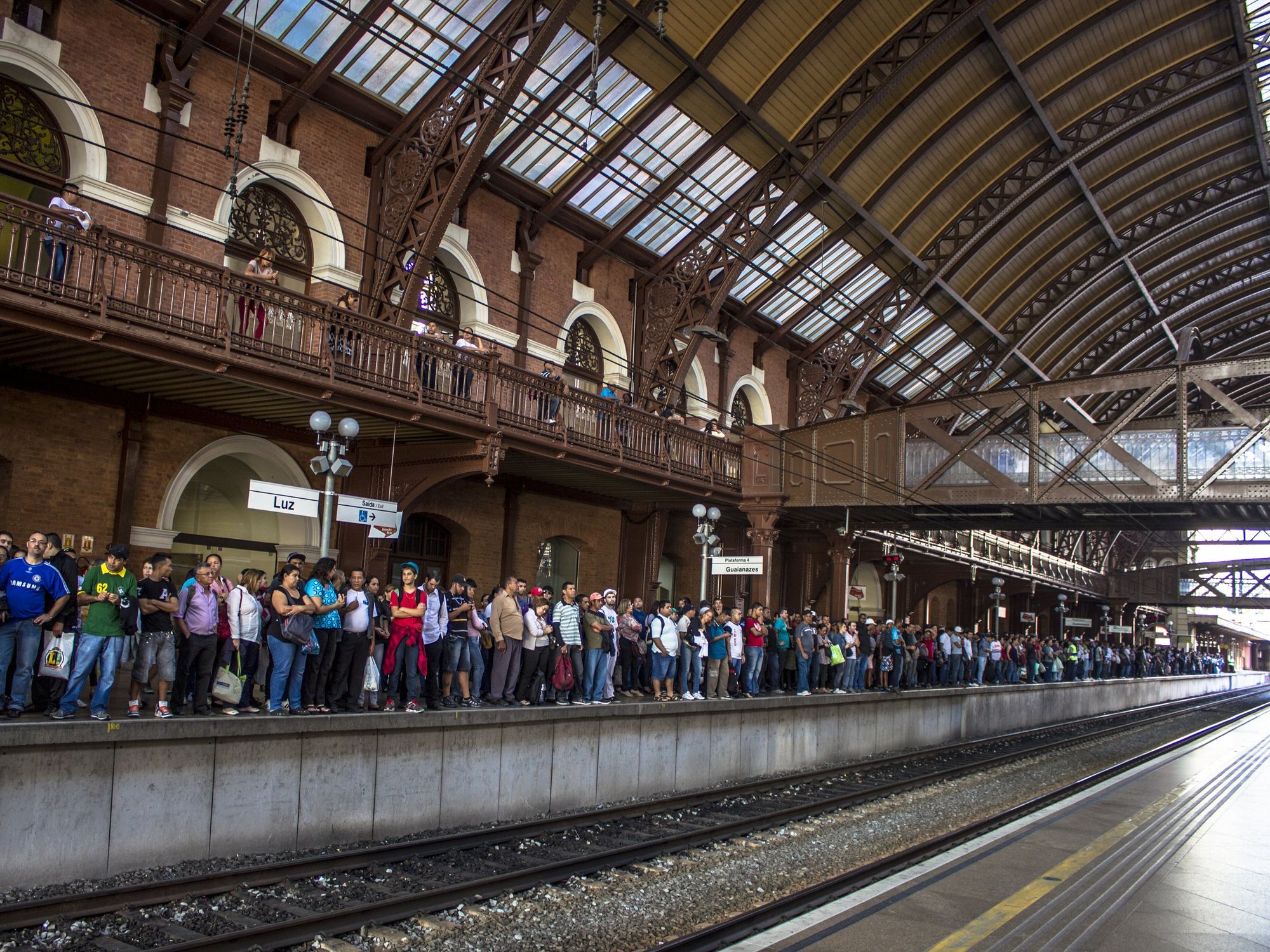 \u200bPeople wait for a train at the boarding platform of the Luz station in the central region of S\u00e3o Paulo.
