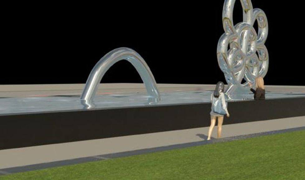 \u200bPeople walk by a metallic floral structure.