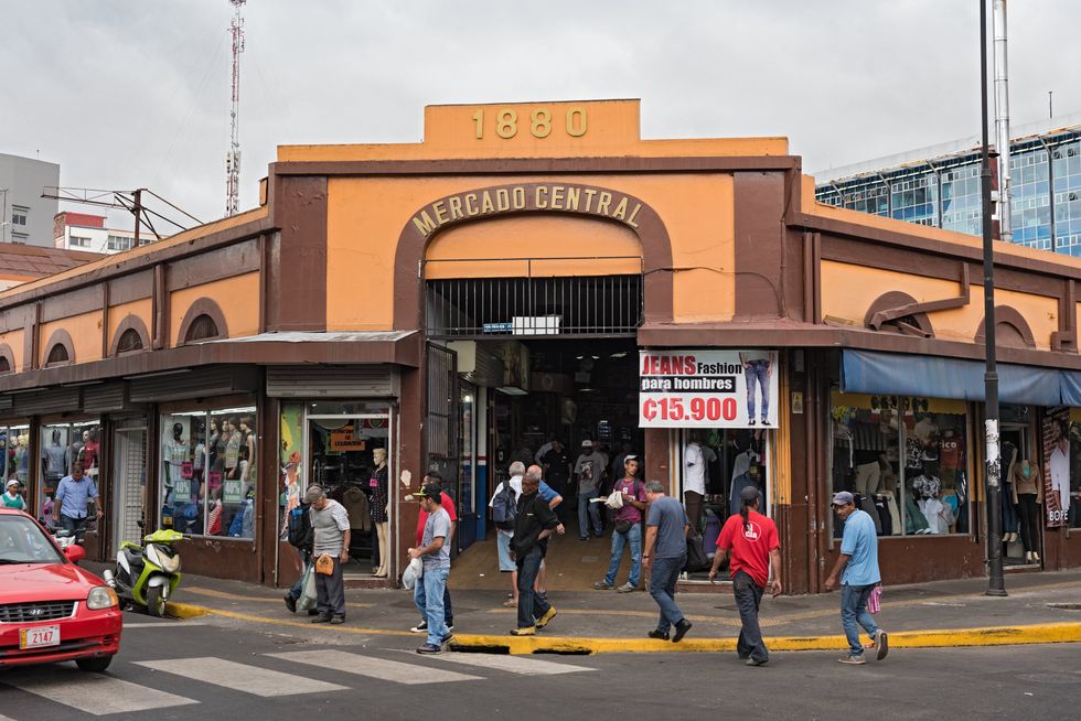 \u200bPeople walk on the street in front of the central market in downtown San Jose.