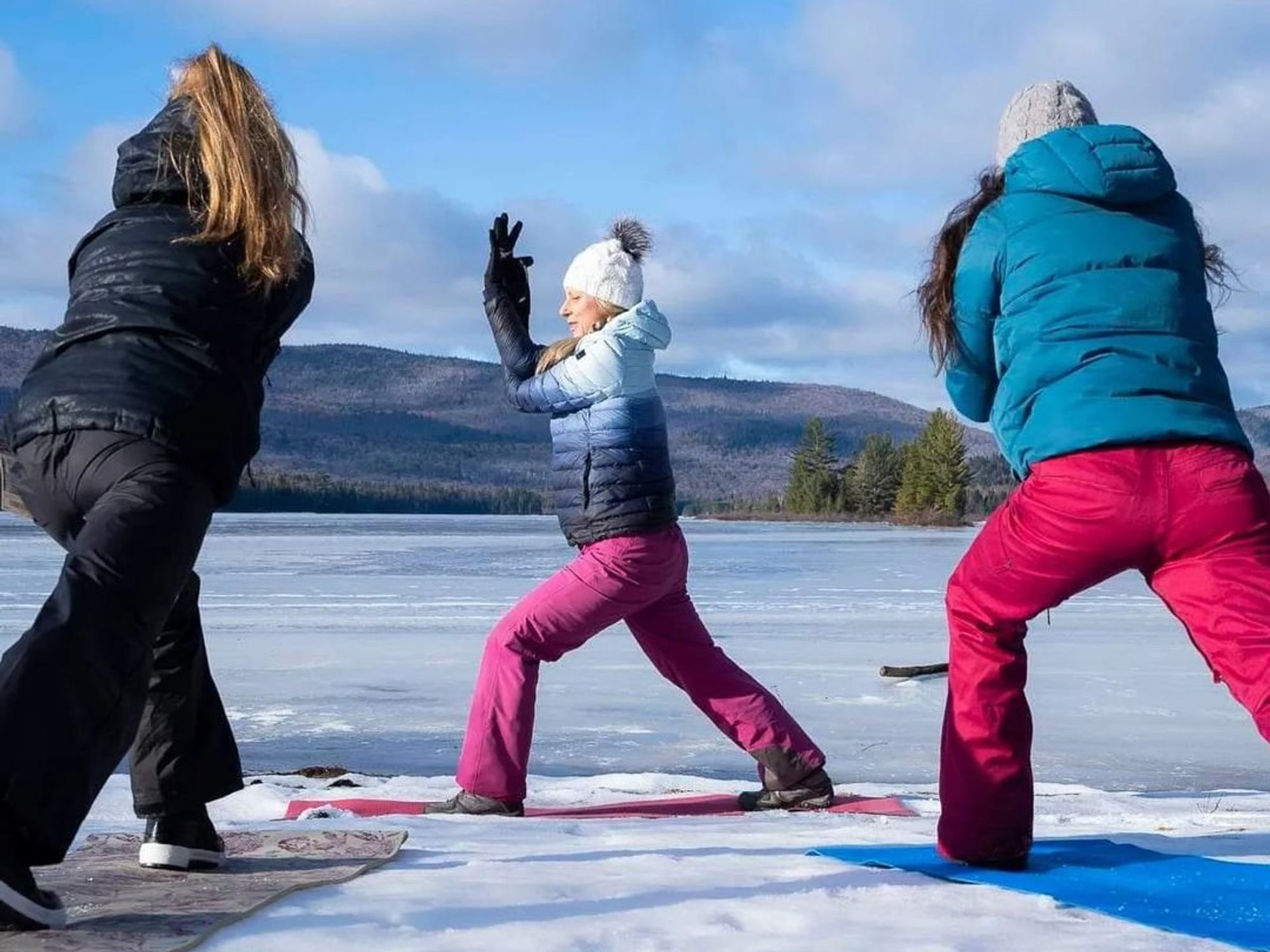 \u200bSomeone in a snowsuit does a yoga pose.