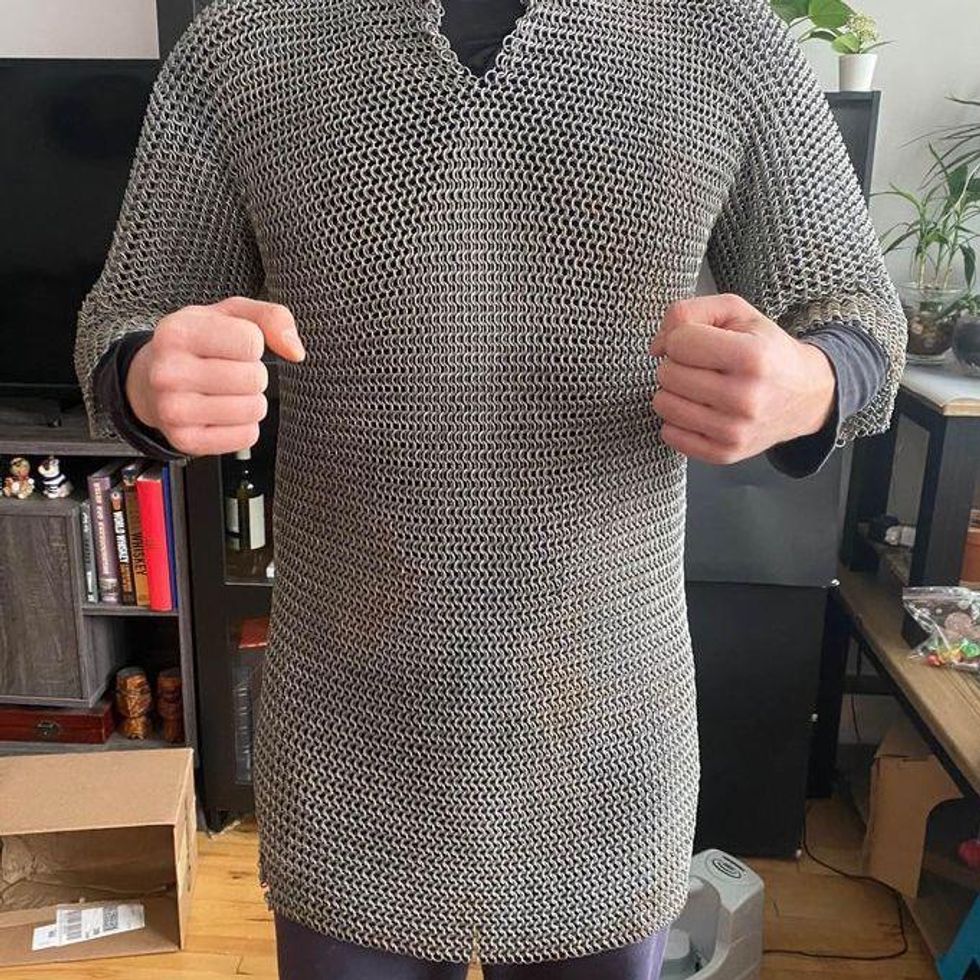 \u200bSomeone poses in a chainmail tunic.
