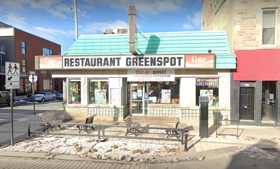 \u200bThe exterior of Restaurant Greenspot in Montreal with the sun beaming directly on the building.