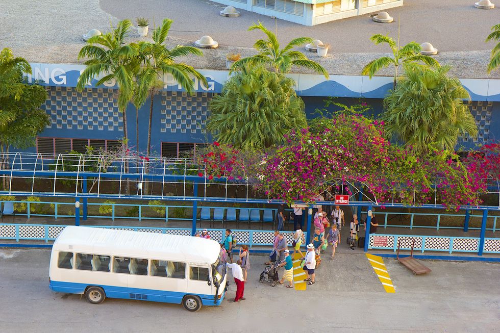 \u200bTourists wait to board a bus in Montego Bay.