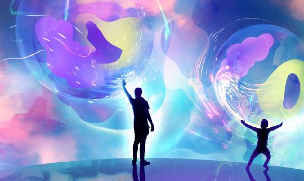 \u200bTwo figures touch pulsating spheres.