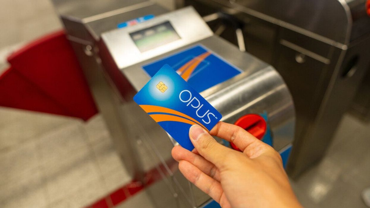 Using the OPUS smart card to enter Montreal Metro Berri-UQAM Station ticket gates.