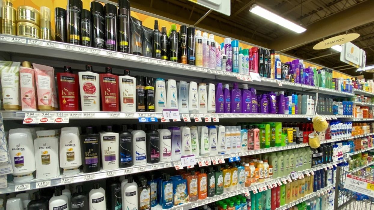 Various haircare products stacked on shelves in a pharmacy in Canada.