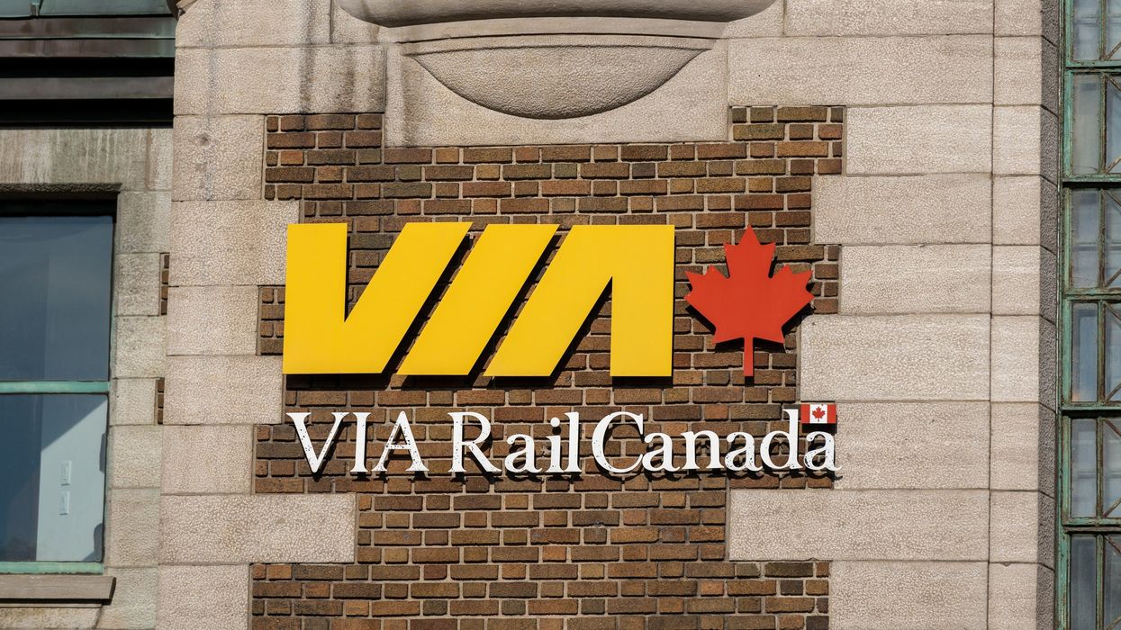 via rail sign on a train station building in quebec