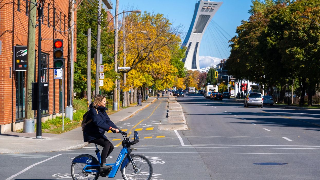 Woman riding a Bixi bike on Rachel street in Autumn.